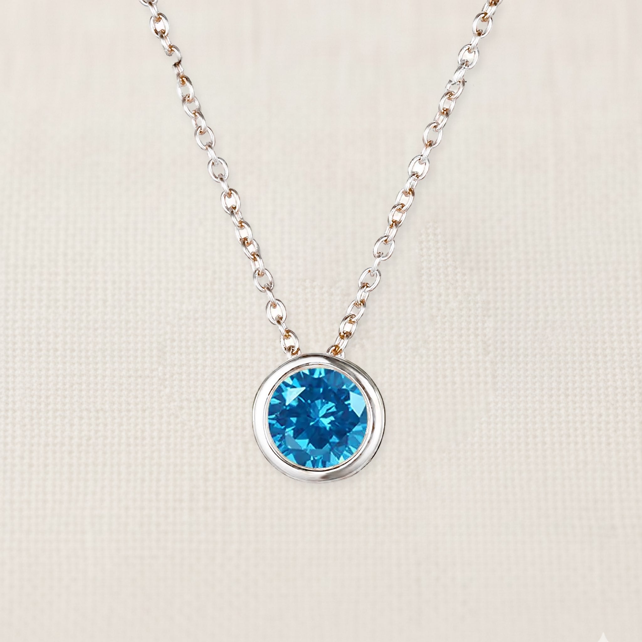 Bezelle Aurora Pendant necklace with blue topaz birthstone in sterling silver