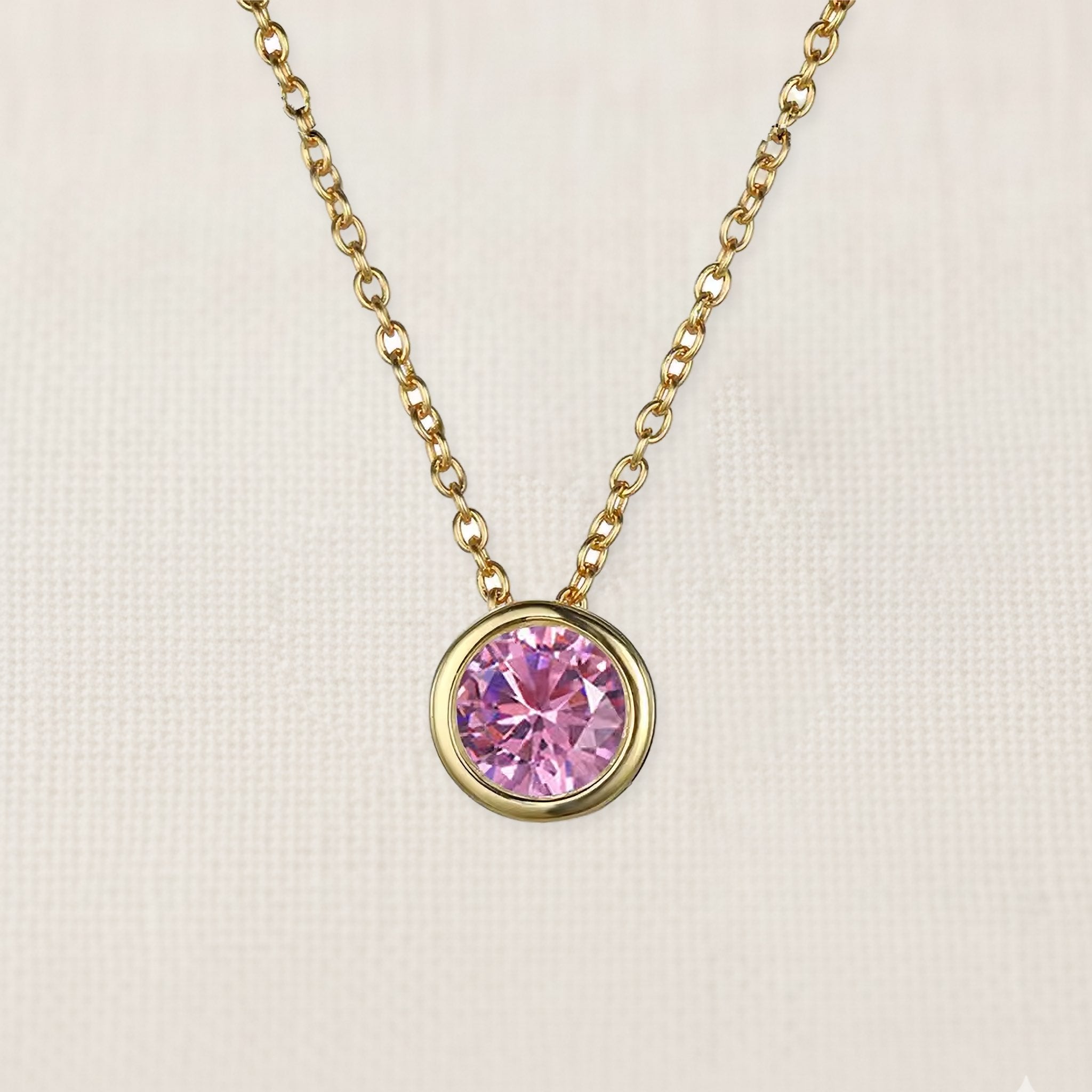 Bezelle Aurora Pendant necklace with pink sapphire birthstone in 14K yellow gold