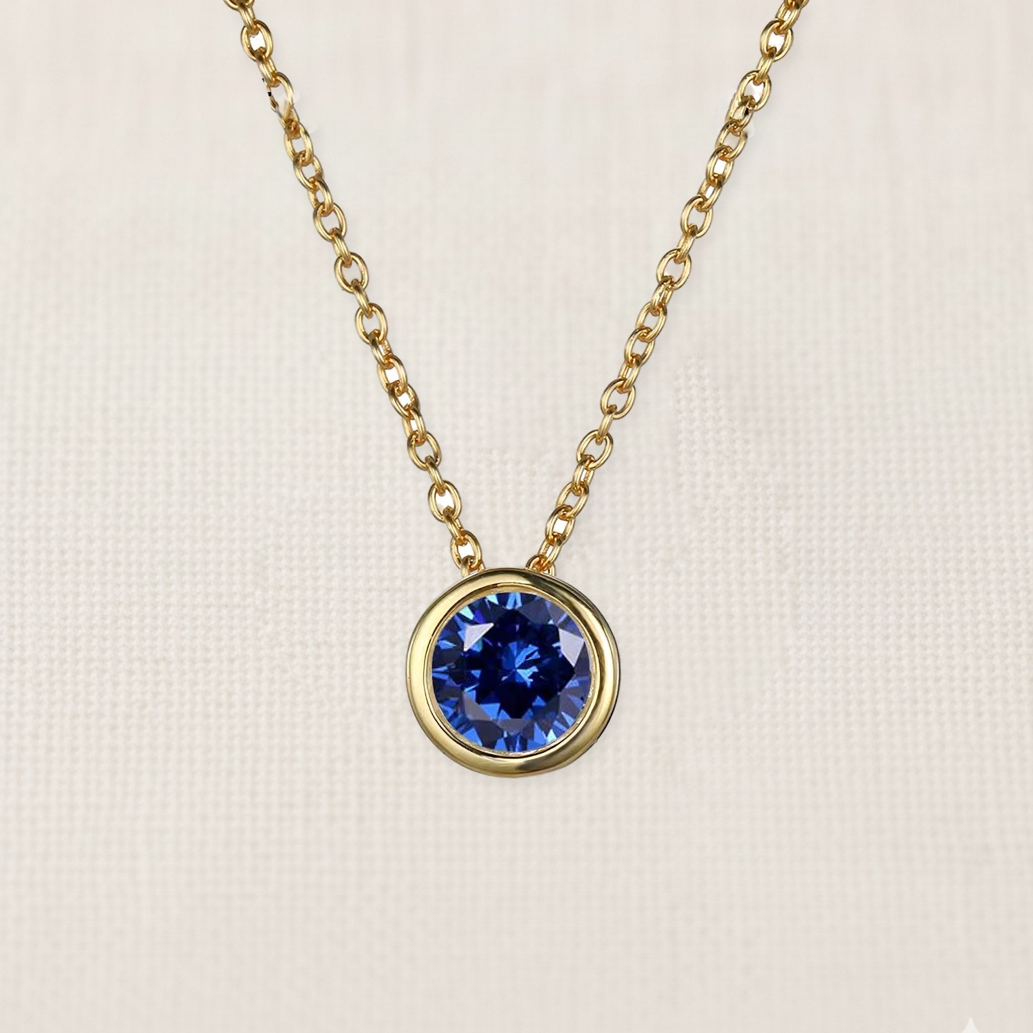 Bezelle Aurora Pendant necklace with sapphire birthstone in 14K yellow gold
