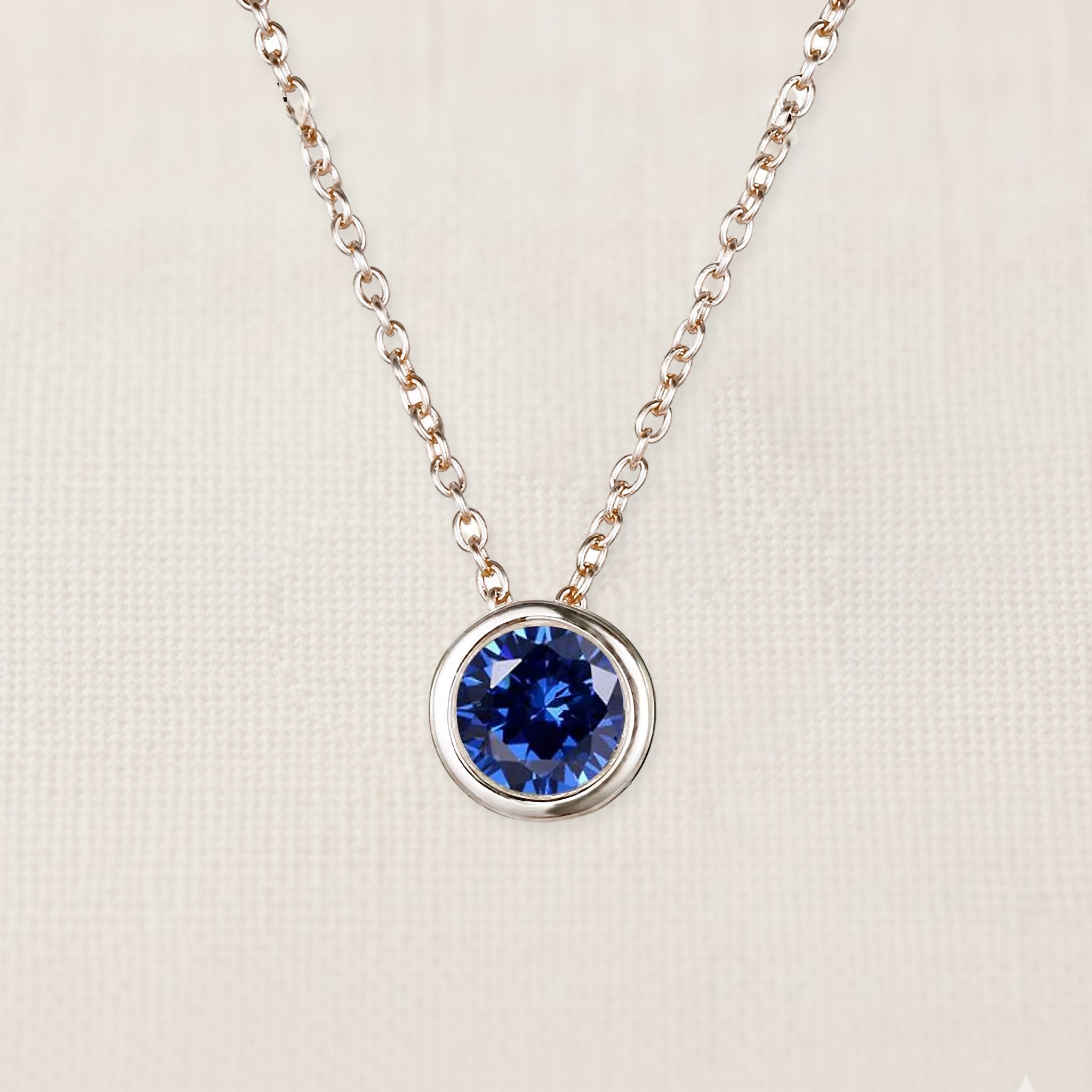 Bezelle Aurora Pendant necklace with sapphire birthstone in sterling silver