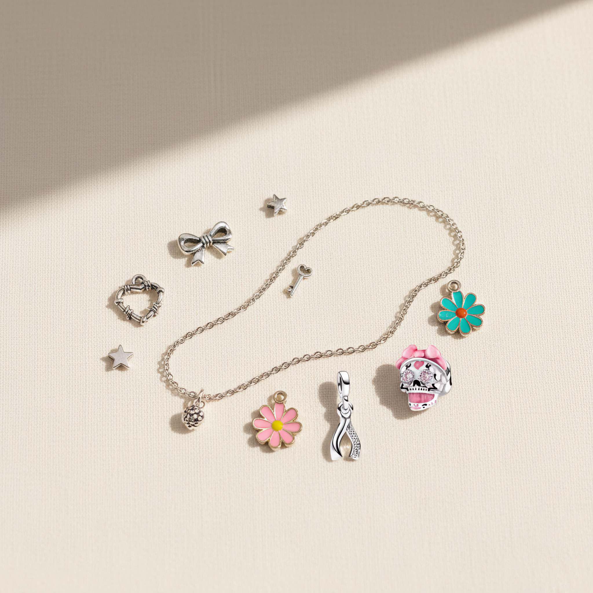 Bezelle Jewelry social proof banner featuring sterling silver charms including heart, bow, flower, and ghost designs.